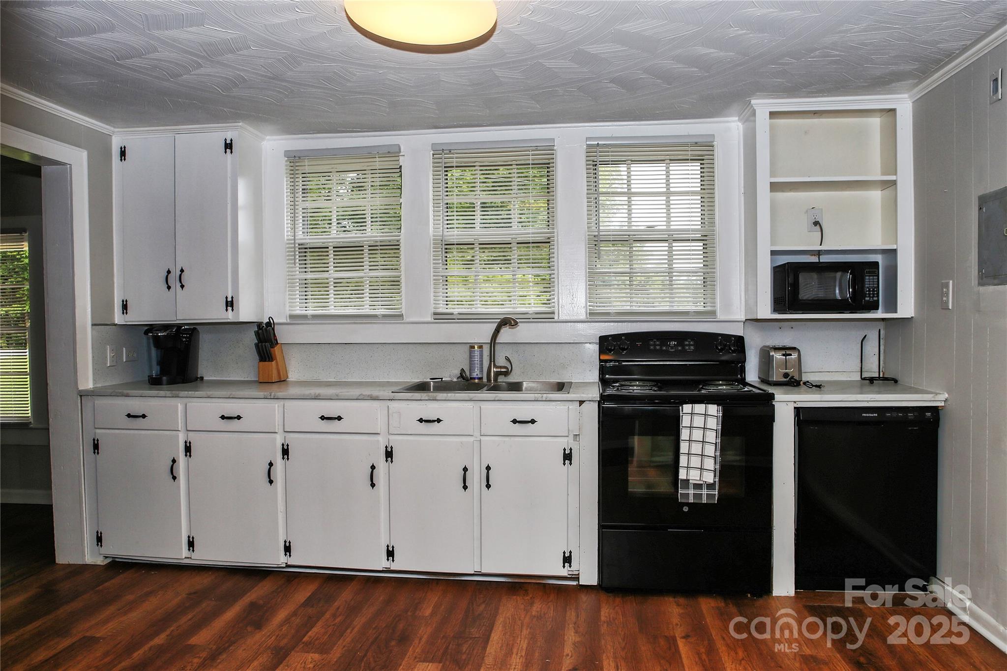 218 Blacksnake Road Stanley, NC 28164 - Photo 15 of 36 a kitchen with stainless steel appliances granite countertop a stove a sink and a microwave