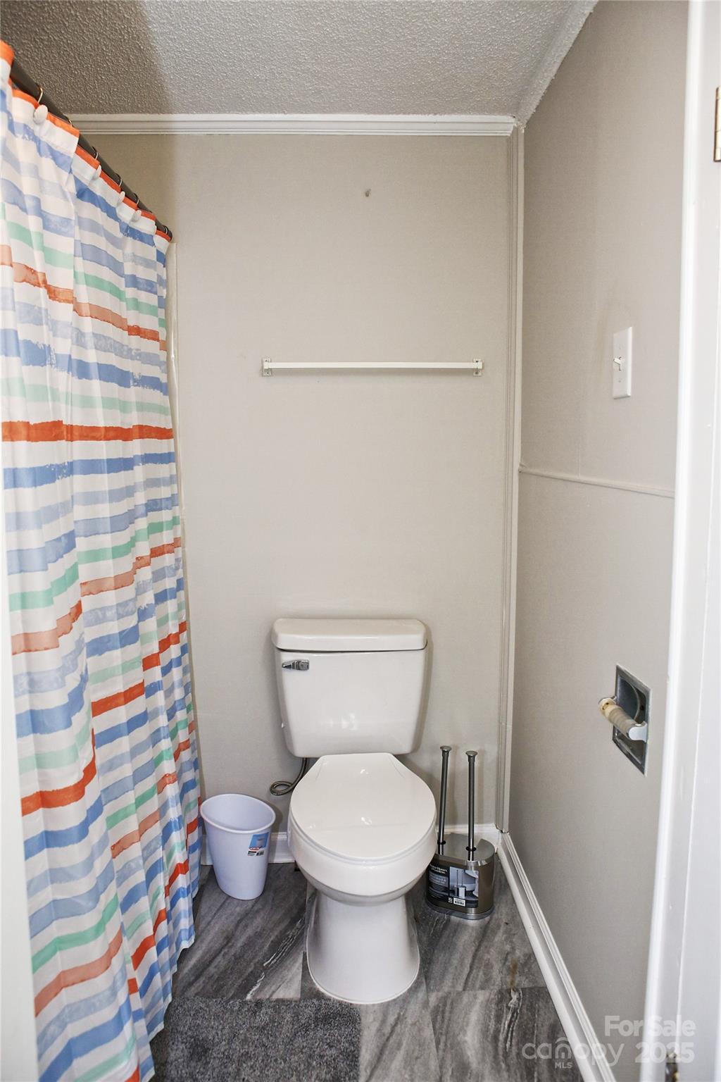 218 Blacksnake Road Stanley, NC 28164 - Photo 29 of 36 a white toilet sitting next to a shower curtain