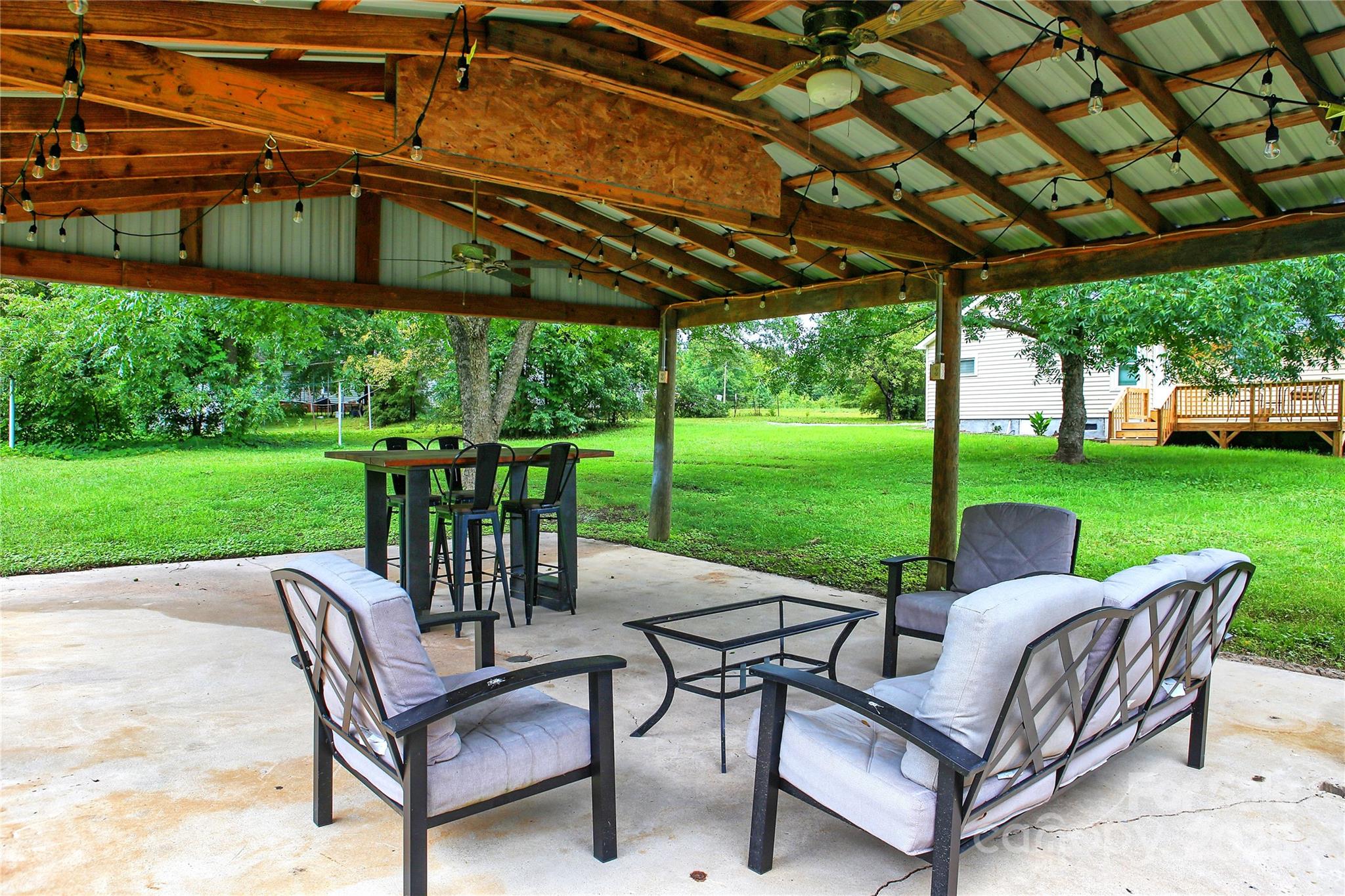 218 Blacksnake Road Stanley, NC 28164 - Photo 5 of 36 a view of a patio with a table chairs and a yard