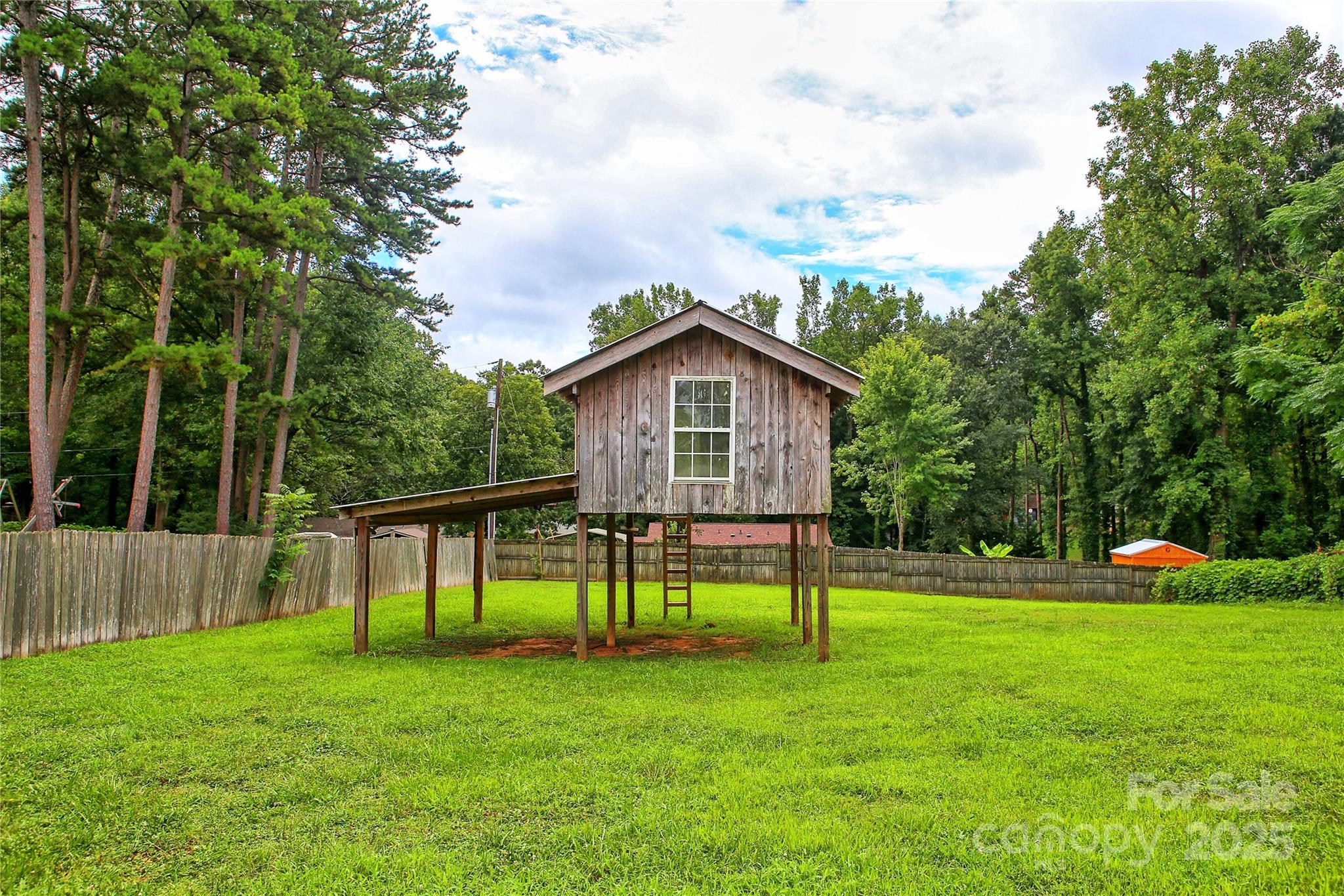 218 Blacksnake Road Stanley, NC 28164 - Photo 6 of 36 a view of house with backyard and a slide