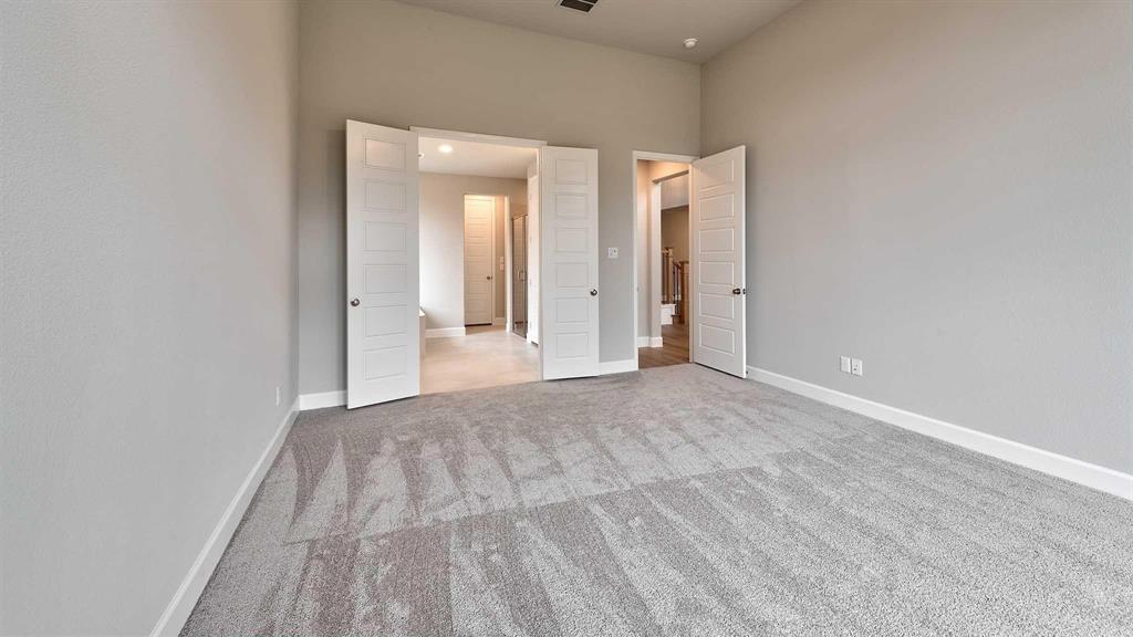 4237 Capstone Road Midlothian, TX 76065 - Photo 20 of 25 Spacious room featuring neutral carpeting, light-toned walls, and multiple panel doors