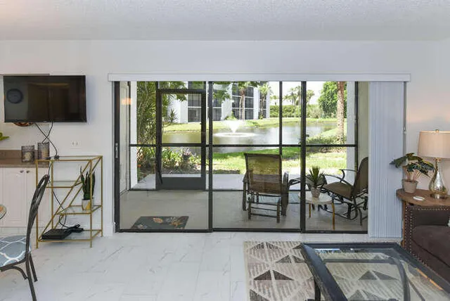 a view of a livingroom with furniture wooden floor and a flat screen tv