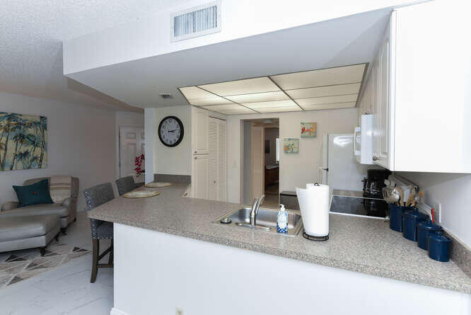1605 Highway 1, Unit B105 Jupiter, FL 33477 - Photo 17 of 30 a view of kitchen with a sink and living room