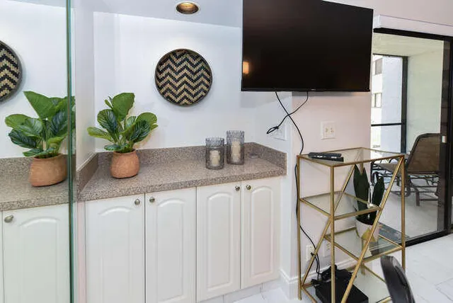 a bathroom with a sink a potted plant and a window