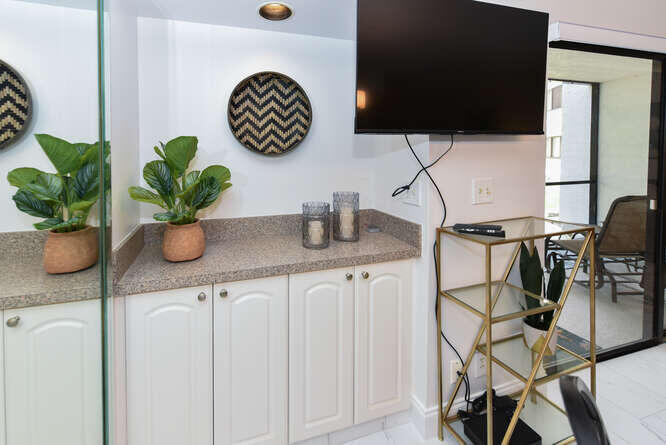 1605 Highway 1, Unit B105 Jupiter, FL 33477 - Photo 19 of 30 a bathroom with a sink a potted plant and a window
