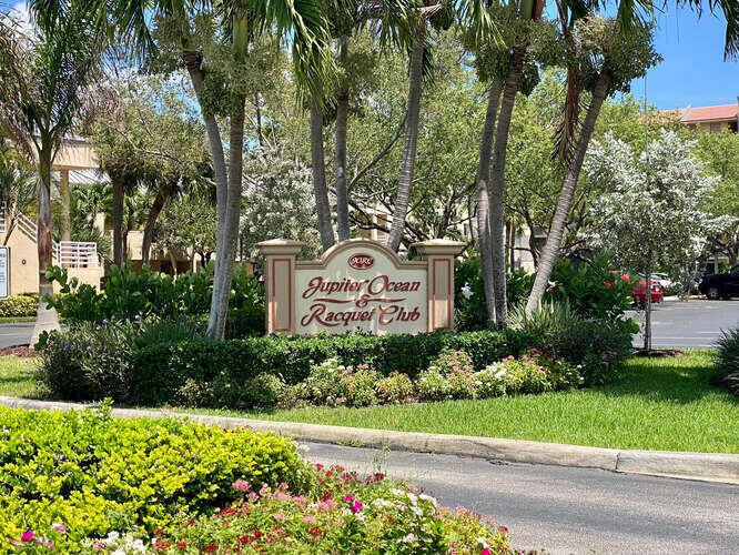 1605 Highway 1, Unit B105 Jupiter, FL 33477 - Photo 2 of 30 a sign on the side of a road