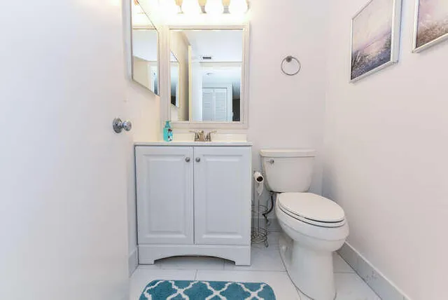 a bathroom with a sink a toilet and mirror