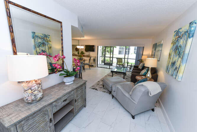 1605 Highway 1, Unit B105 Jupiter, FL 33477 - Photo 3 of 30 a living room with furniture and a potted plant