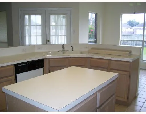 a kitchen with a sink and large window