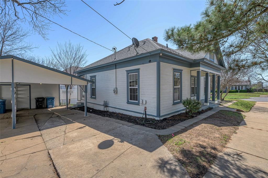 1231 West Main Street Denison, TX 75020 - Photo 13 of 31 a view of a house with a yard