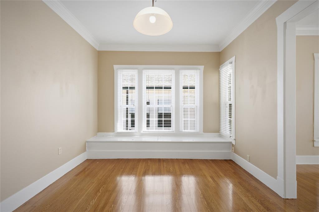 1231 West Main Street Denison, TX 75020 - Photo 18 of 31 a view of an empty room with wooden floor and a window