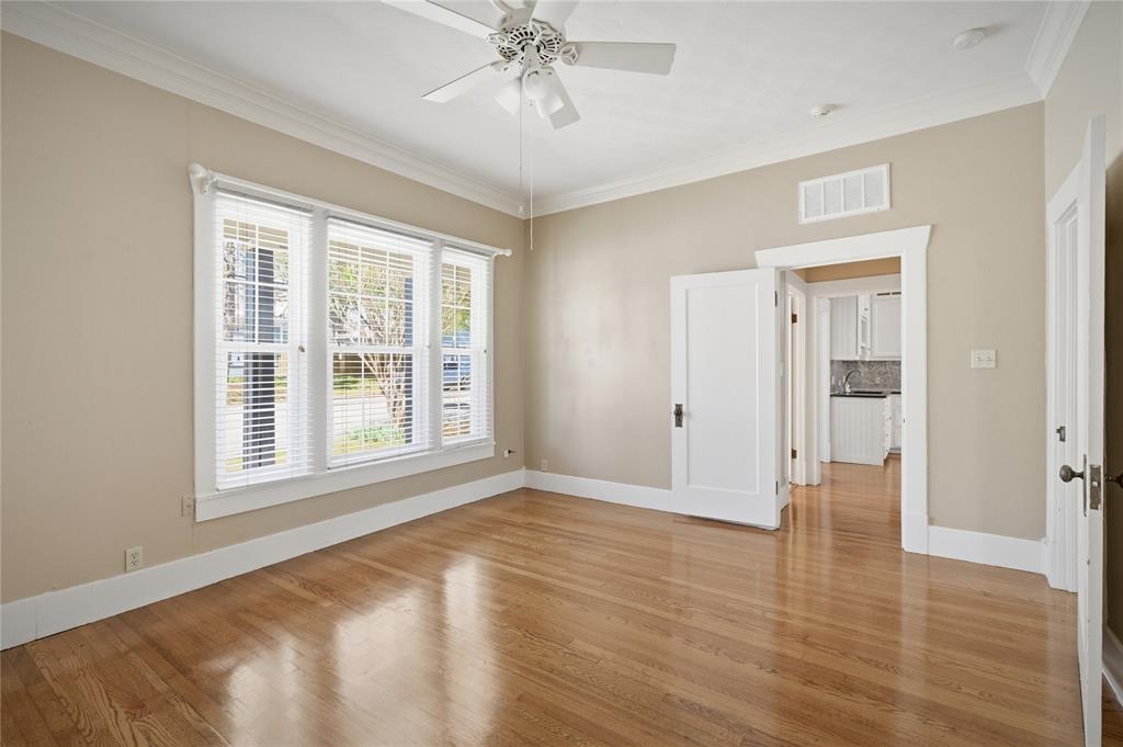 1231 West Main Street Denison, TX 75020 - Photo 24 of 31 a view of an empty room with wooden floor and a window