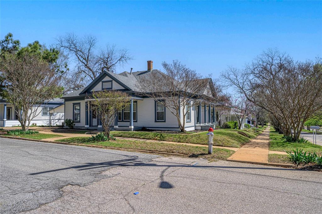 1231 West Main Street Denison, TX 75020 - Photo 3 of 31 a front view of a house with a yard
