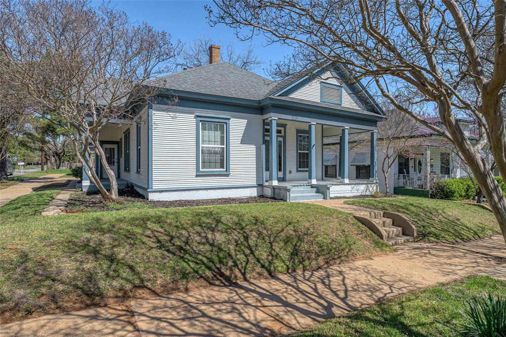 1231 West Main Street Denison, TX 75020 - Photo 4 of 31 a front view of a house with a yard