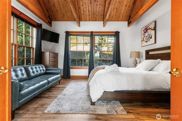 a bed sitting in a bedroom next to a window