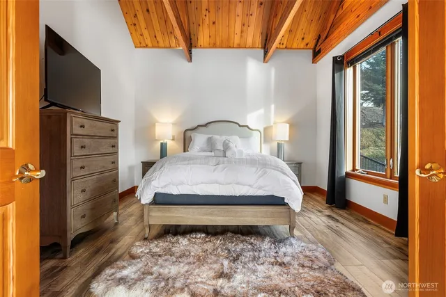 a bed sitting in a bedroom next to a window