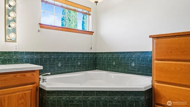 an empty room with closet and a chandelier fan