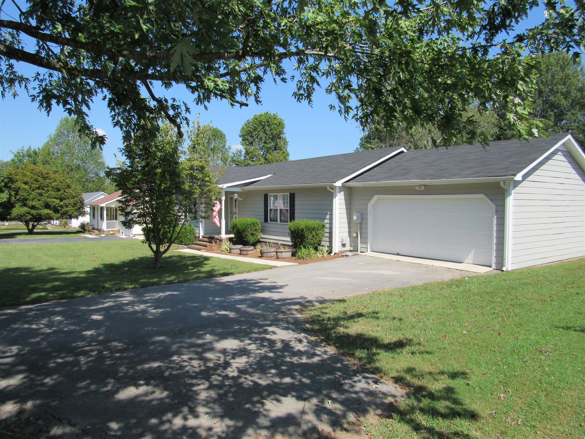 1070 Riley Creek Road Tullahoma, TN 37388 - Photo 2 of 17 a front view of a house with a yard and garage