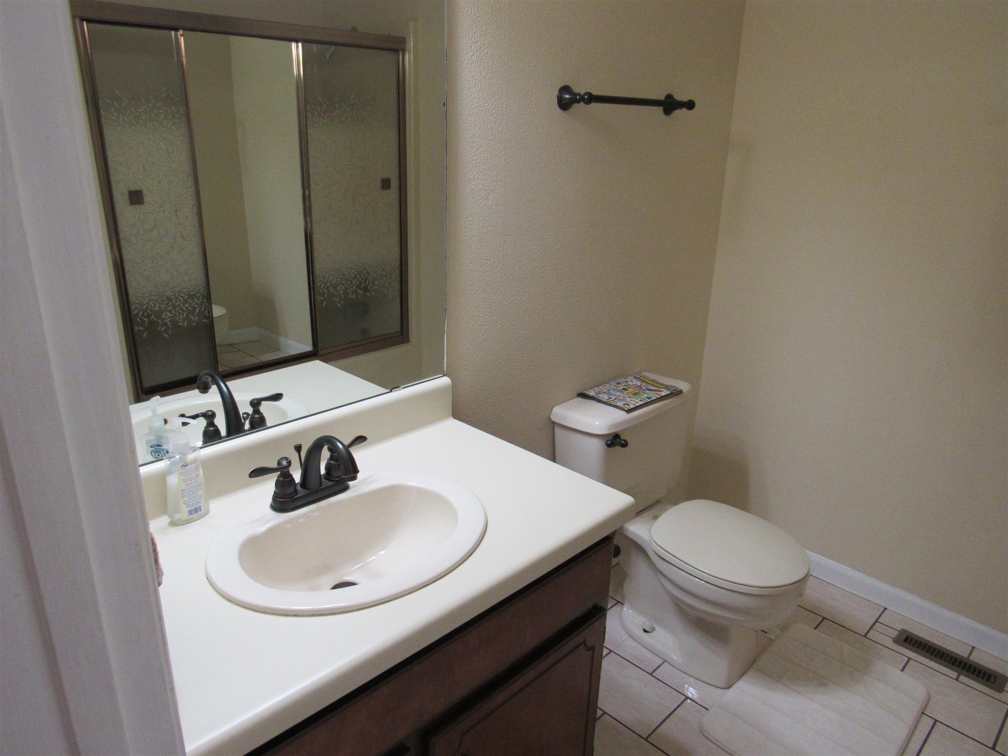 1070 Riley Creek Road Tullahoma, TN 37388 - Photo 12 of 17 a bathroom with a sink toilet and mirror