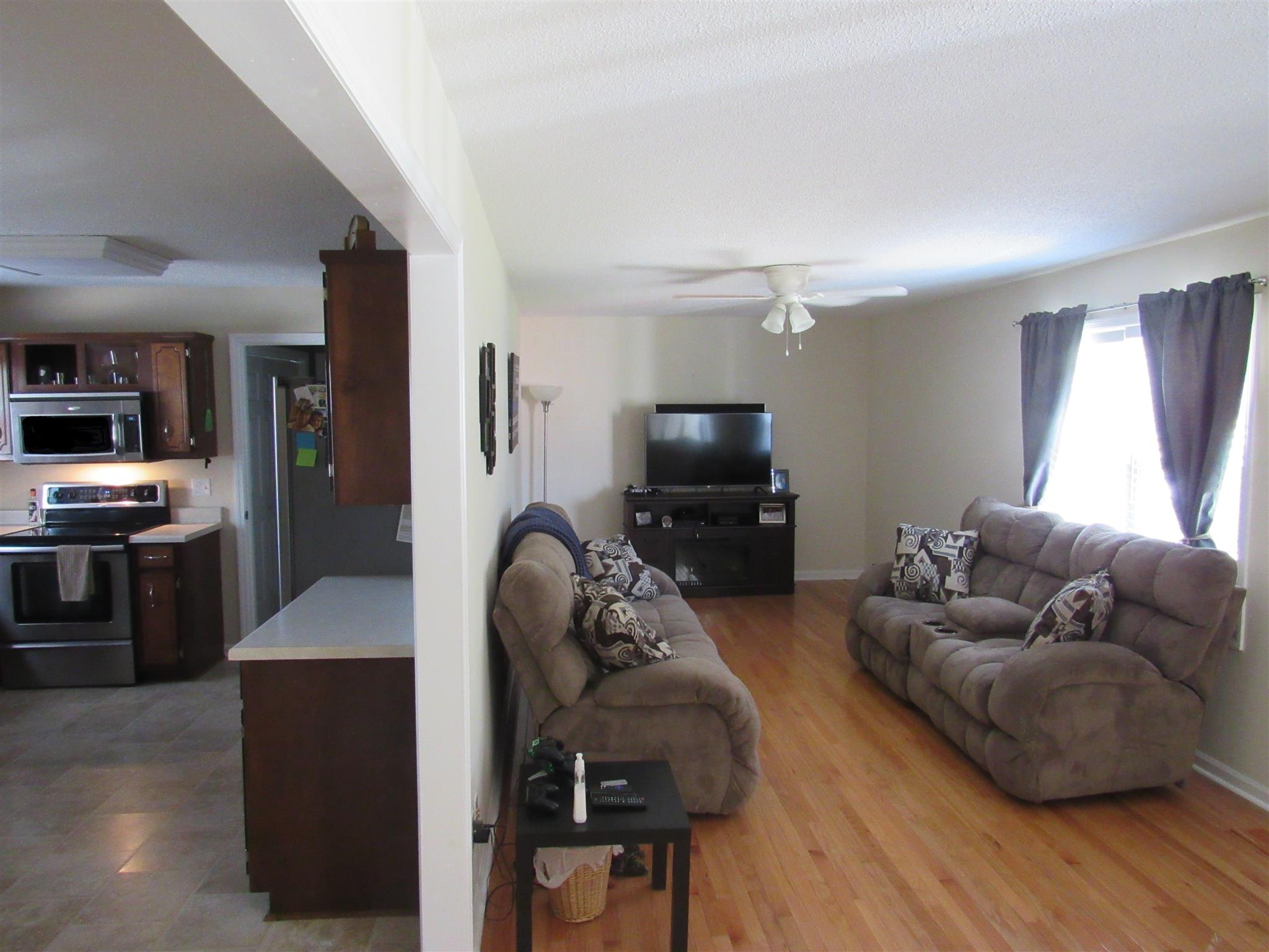 1070 Riley Creek Road Tullahoma, TN 37388 - Photo 4 of 17 a living room with furniture and a flat screen tv