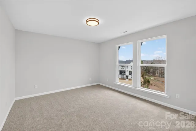 a view of an empty room and a window