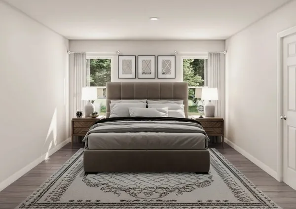 a bed sitting in a bedroom next to a window