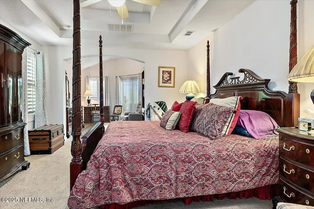 a bedroom with a bed a couch and dresser