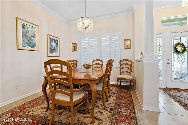 a living room with furniture a dining table with wooden floor and windows