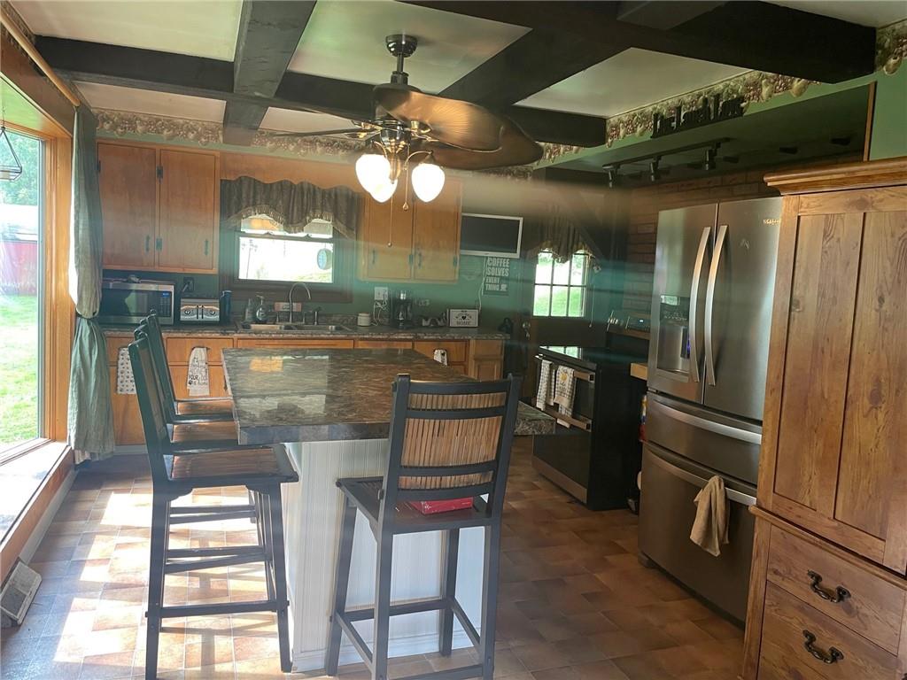 600 Wises Grove Road New Brighton, PA 15066 - Photo 3 of 13 a kitchen with stainless steel appliances kitchen island granite countertop a refrigerator and microwave