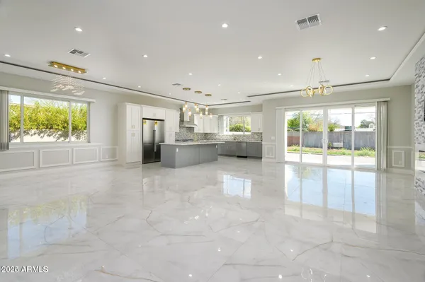 a open kitchen with stainless steel appliances granite countertop a refrigerator and a sink