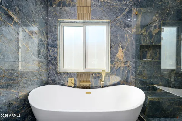a white bath tub sitting in a bathroom