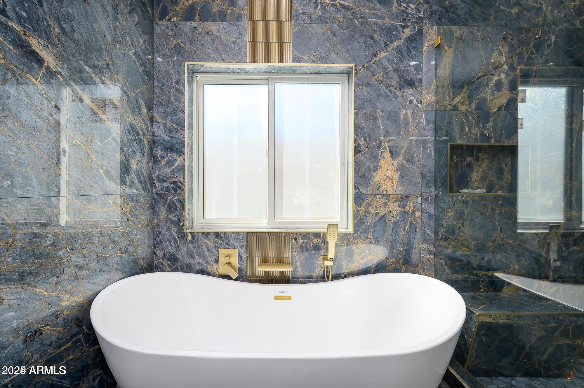 6729 North 13th Street Phoenix, AZ 85014 - Photo 15 of 24 a white bath tub sitting in a bathroom