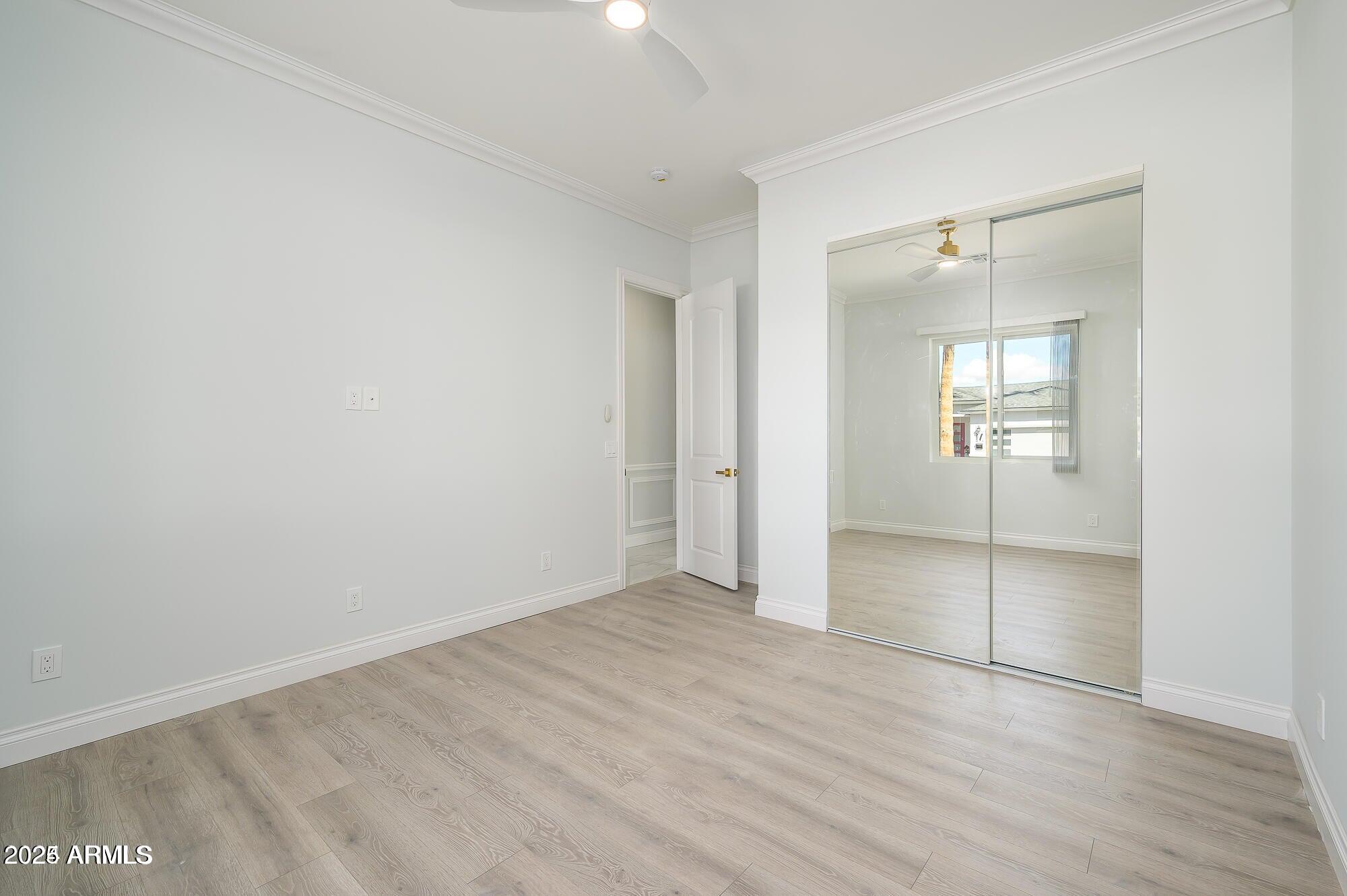 6729 North 13th Street Phoenix, AZ 85014 - Photo 18 of 24 an empty room with mirror and a bathroom
