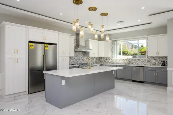 a kitchen with stainless steel appliances a sink stove and refrigerator
