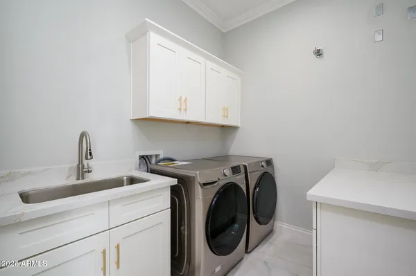 a utility room with sink dryer and washer