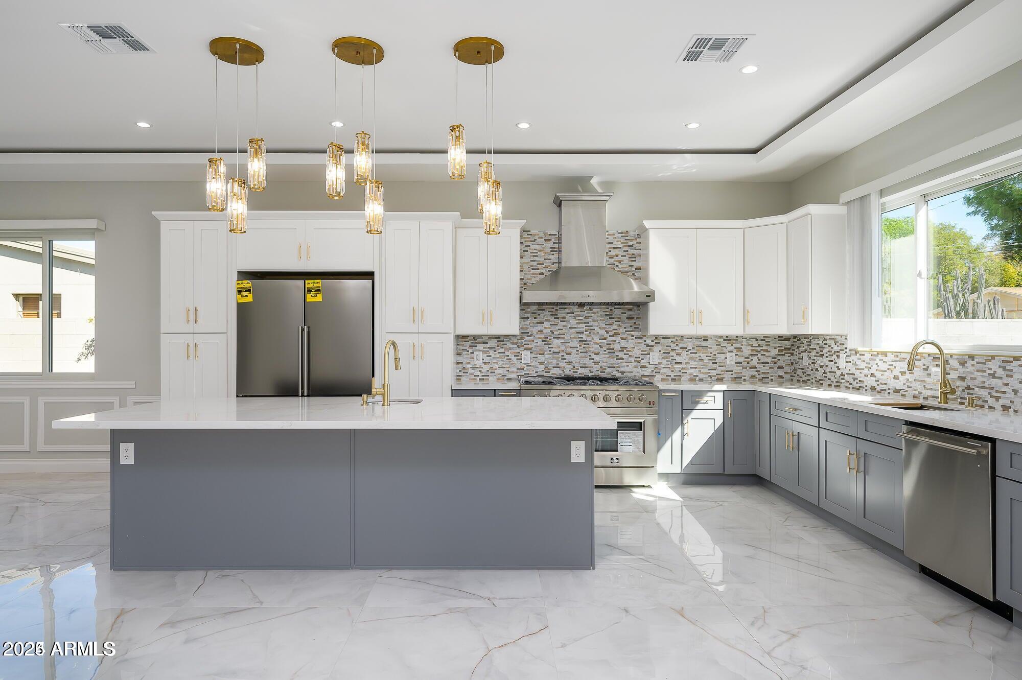6729 North 13th Street Phoenix, AZ 85014 - Photo 3 of 24 a large kitchen with kitchen island a sink stainless steel appliances and cabinets