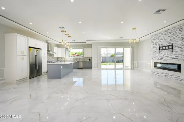 a large white kitchen with a large window