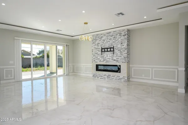 a view of an empty room with a fireplace and a window