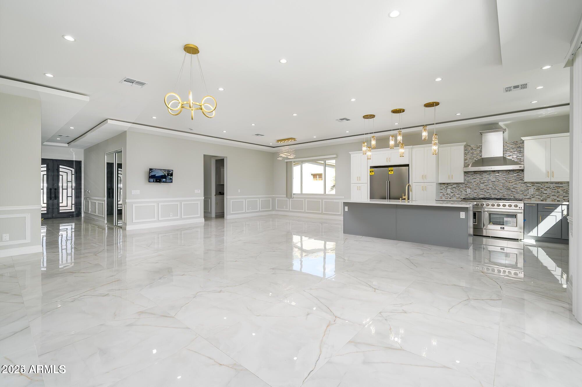 6729 North 13th Street Phoenix, AZ 85014 - Photo 10 of 24 a view of a kitchen with kitchen island stainless steel appliances refrigerator stove microwave and cabinets