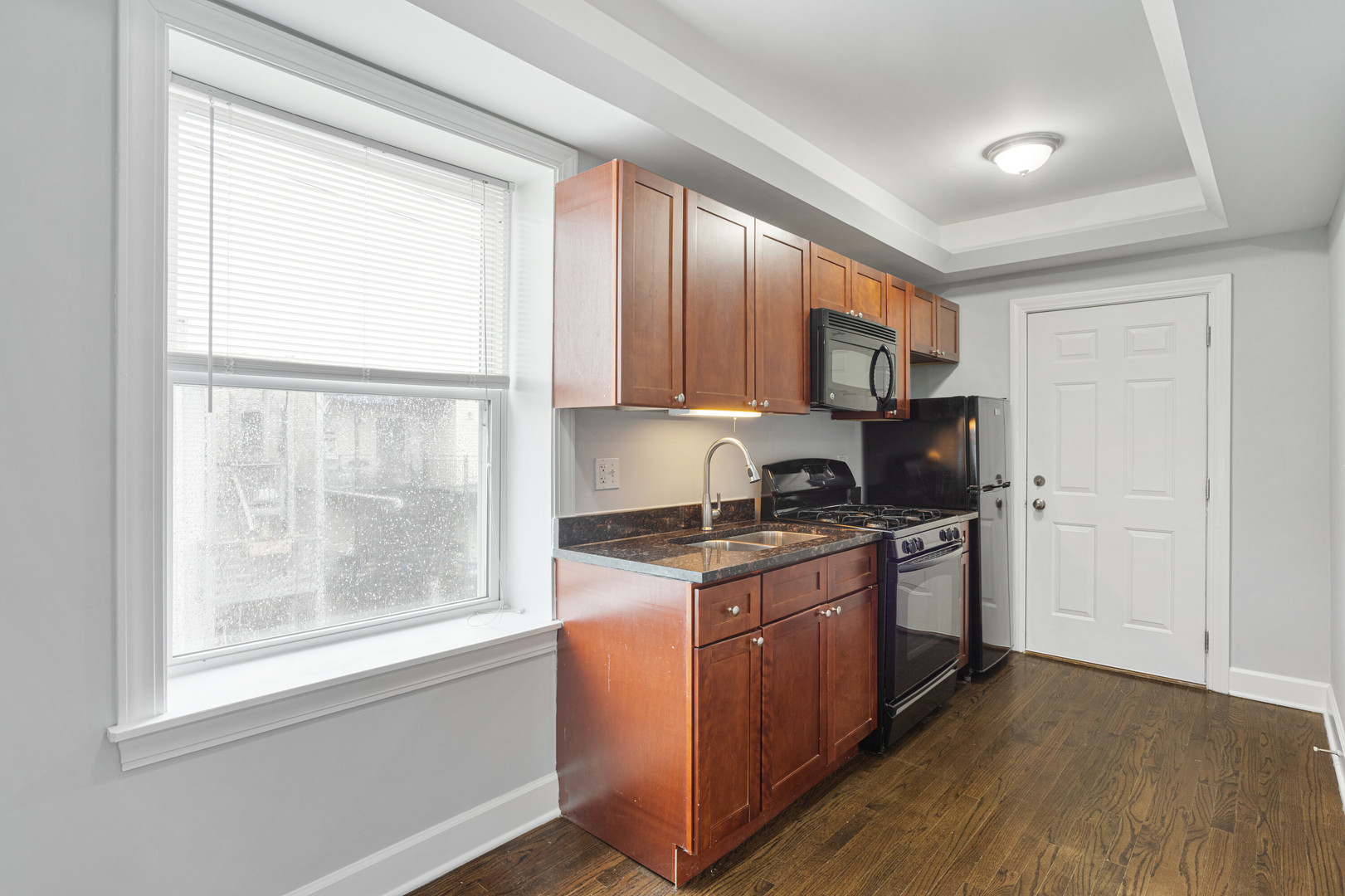 7728 North Ashland Avenue, Unit D2 Chicago, IL 60626 - Photo 4 of 9 a kitchen with stainless steel appliances granite countertop a stove a sink and a refrigerator