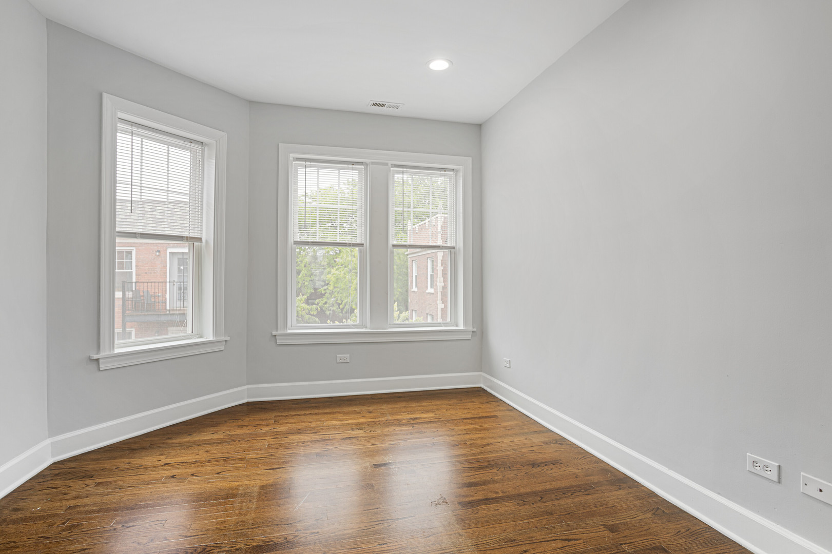 7728 North Ashland Avenue, Unit D2 Chicago, IL 60626 - Photo 7 of 9 an empty room with wooden floor and windows