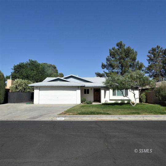 1104 North Inyo Street Ridgecrest, CA 93555 - Photo 1 of 31 a front view of a house with a garden