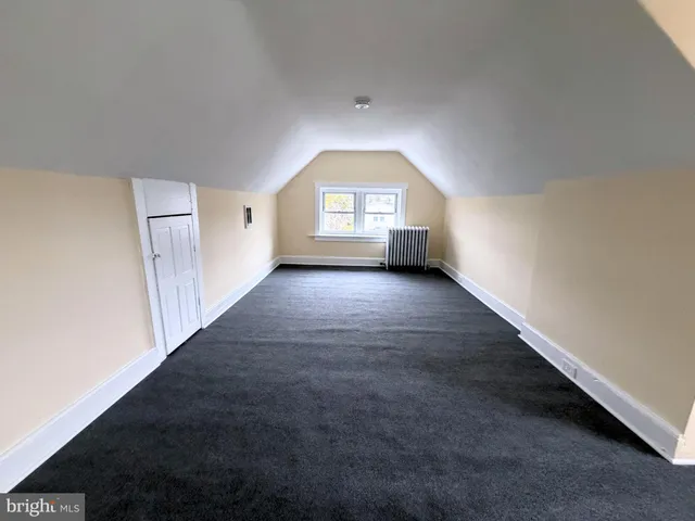 a view of a hallway with wooden walls and a fireplace
