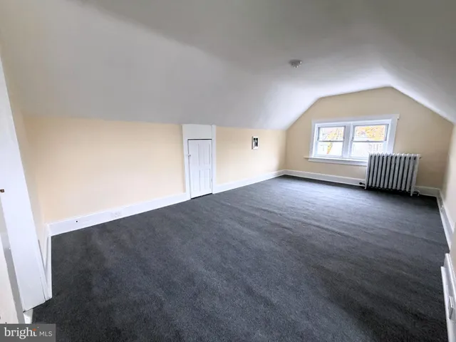 an empty room with windows and cabinet