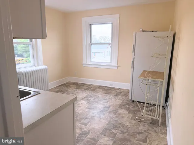 a view of a hallway with windows and lounge chair