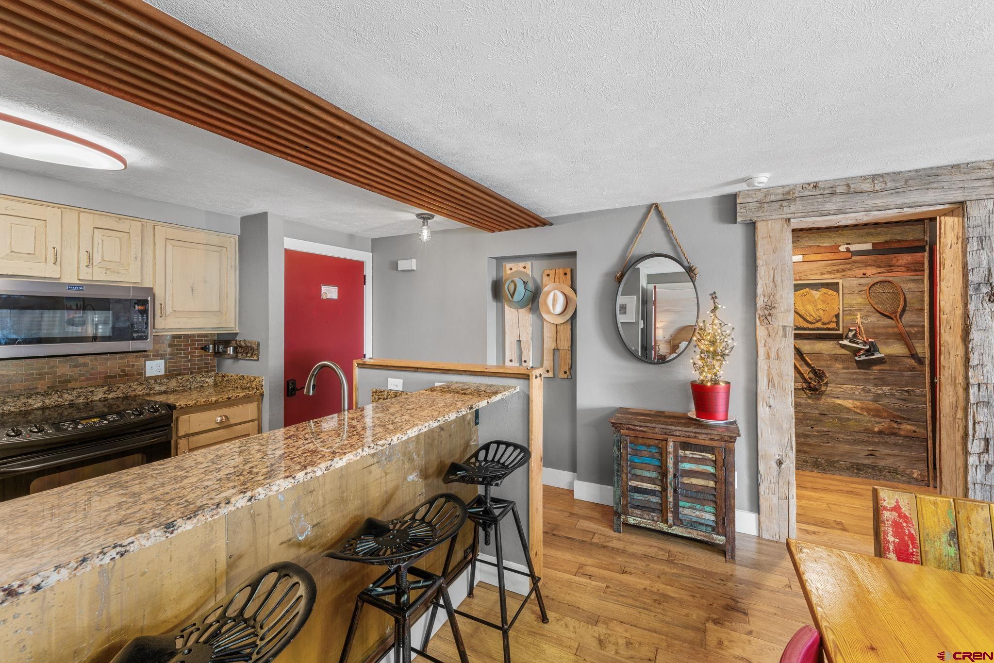 651 Gothic Road, Unit 505 Crested Butte, CO 81225 - Photo 12 of 44 a kitchen with stainless steel appliances granite countertop a stove and cabinets