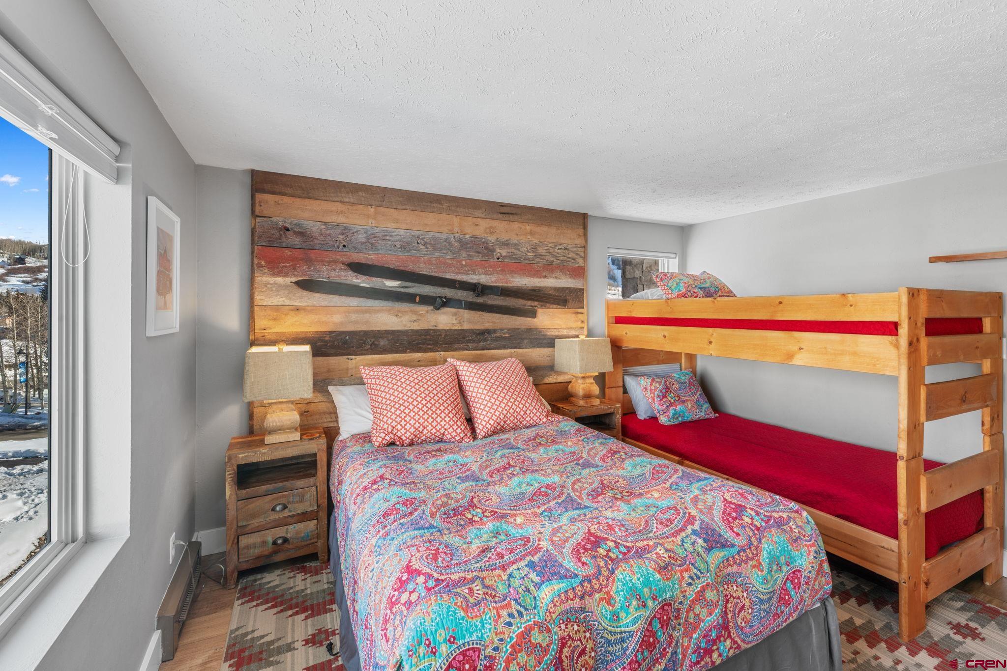 651 Gothic Road, Unit 505 Crested Butte, CO 81225 - Photo 20 of 44 a bedroom with a bed and wooden floor