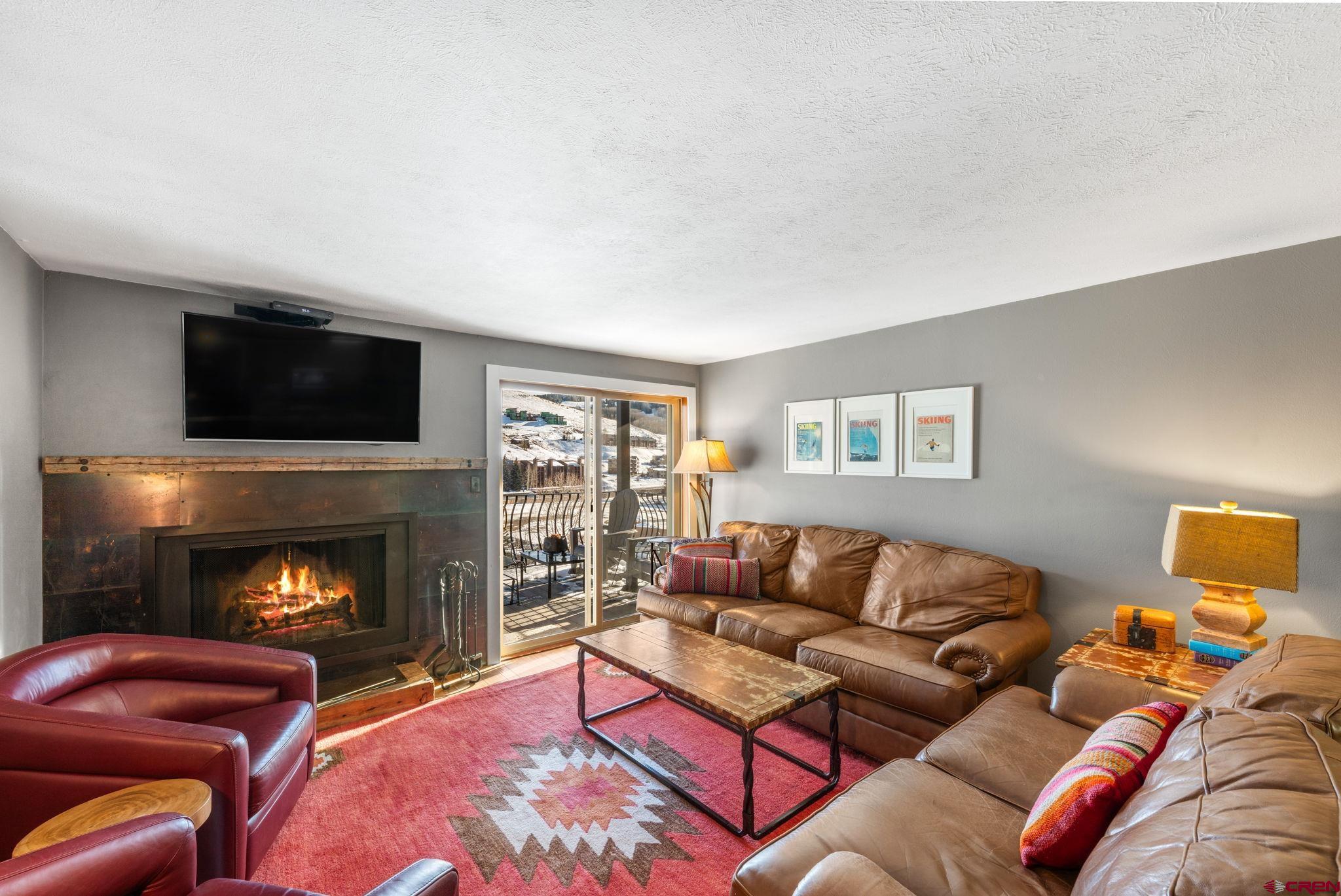 651 Gothic Road, Unit 505 Crested Butte, CO 81225 - Photo 5 of 44 a living room with furniture and a fireplace