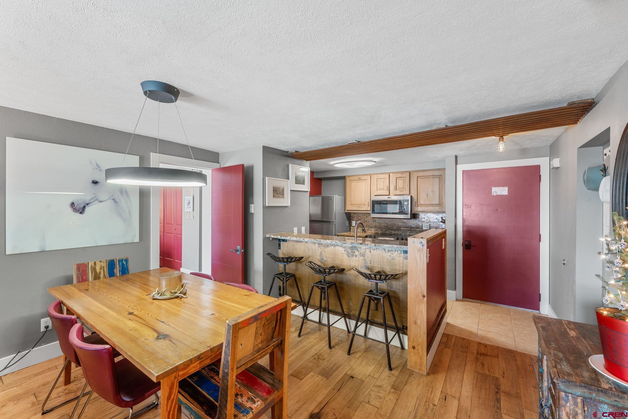 651 Gothic Road, Unit 505 Crested Butte, CO 81225 - Photo 7 of 44 a view of a dining room with furniture and wooden floor