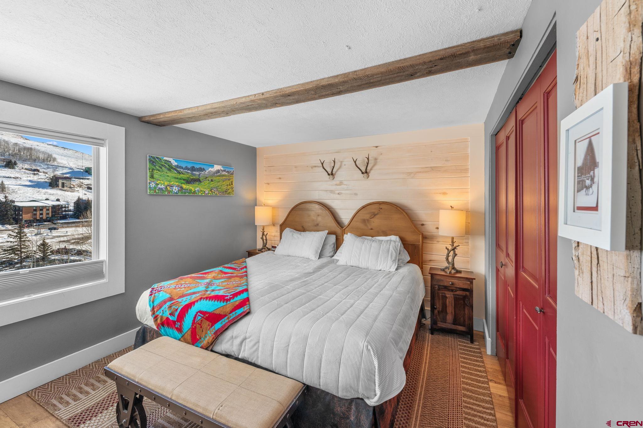 651 Gothic Road, Unit 505 Crested Butte, CO 81225 - Photo 8 of 44 a bed sitting in a bedroom next to a window